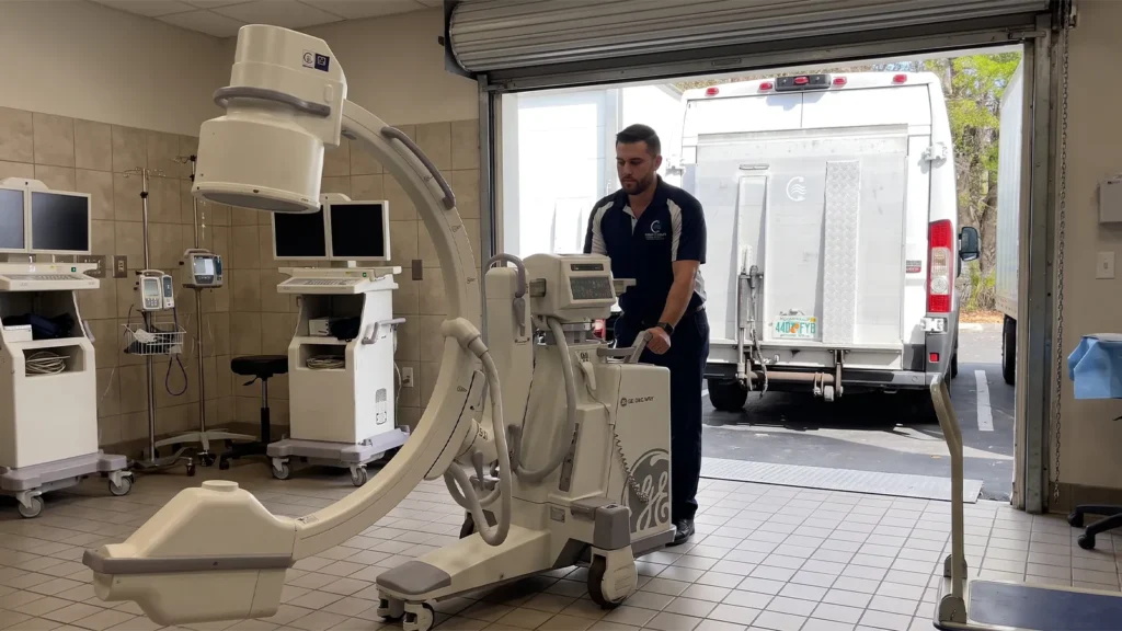 Coast to Coast Radiology delivering and setting up a rental c-arm at a Florida procedure room