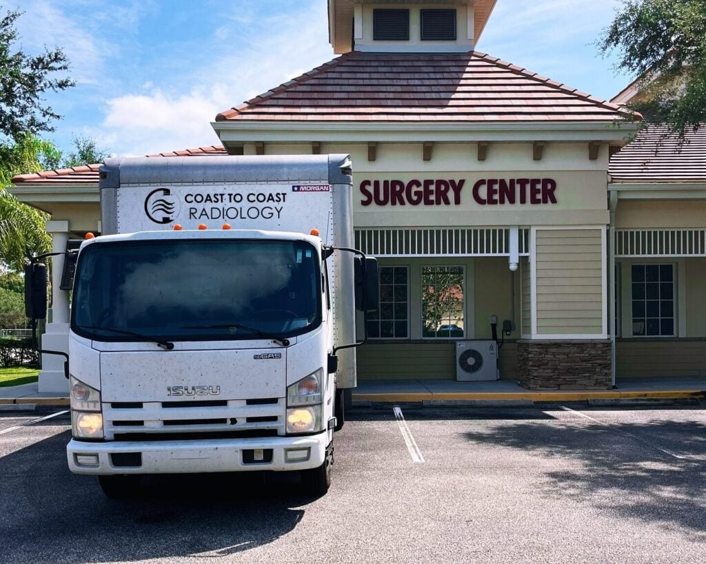 Coast To Coast Radiology delivery truck parked in front of a surgery center By Coast To Coast Radiology
