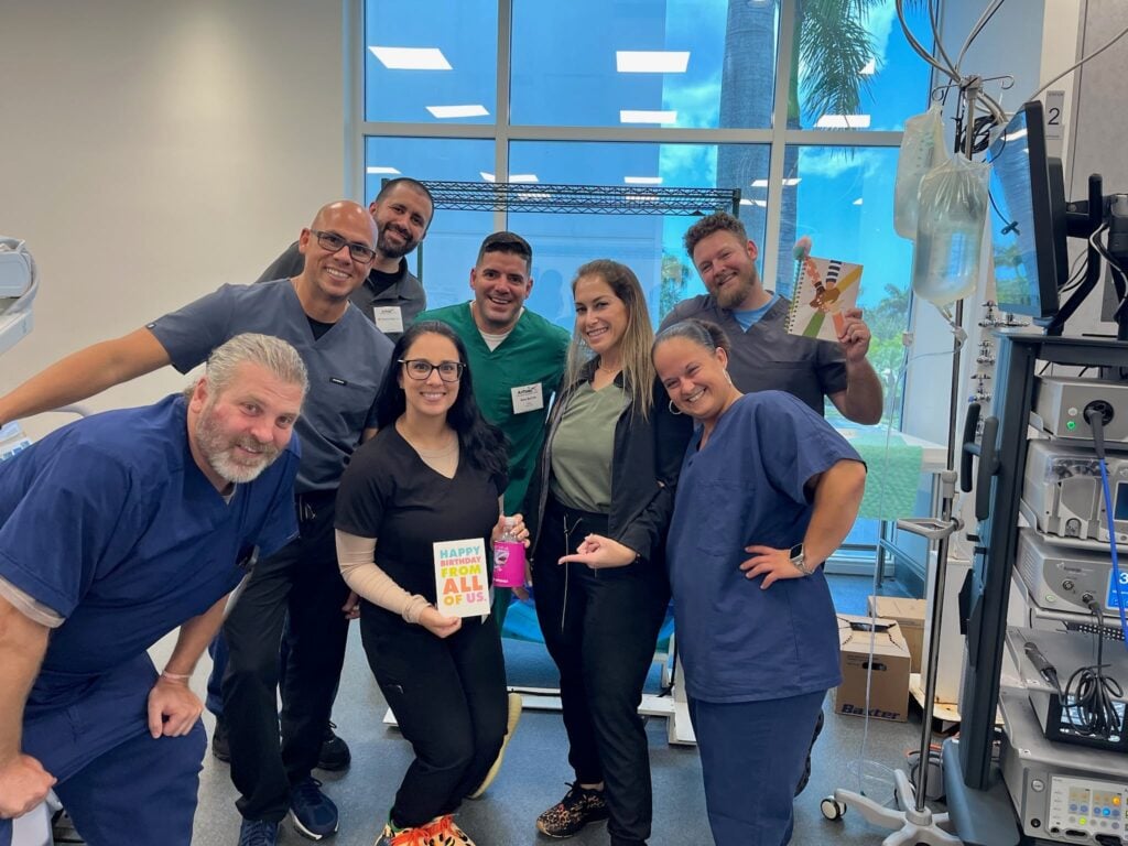 C2C staff team celebrating a birthday in a surgery center By Coast To Coast Radiology