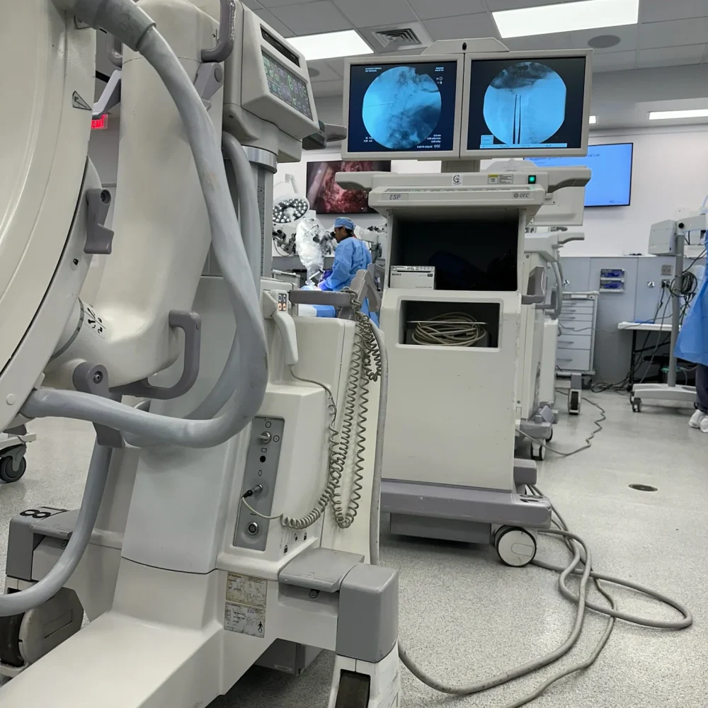 Full side profile of GE OEC 9900 Elite C-Arm system displaying dual monitors and C-arm structure.